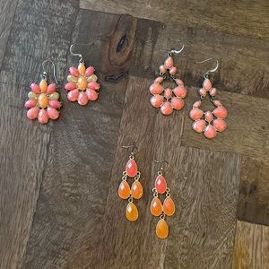 Set of three pink and orange dangly earrings.